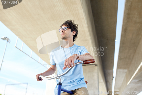 Image of young hipster man riding fixed gear bike