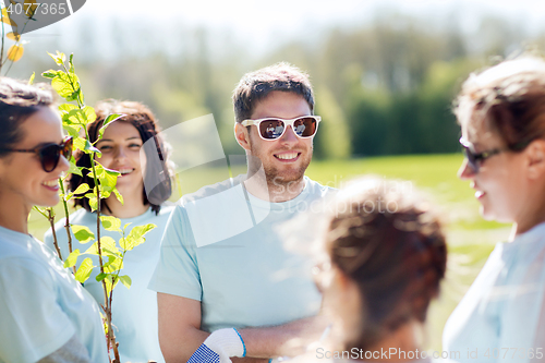 Image of group of volunteers planting trees in park