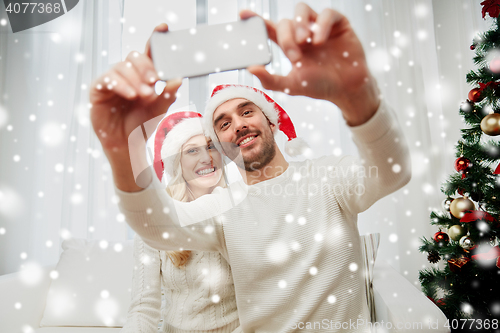Image of couple taking selfie with smartphone at christmas