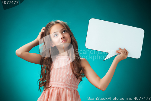 Image of The cute cheerful little girl on orange background