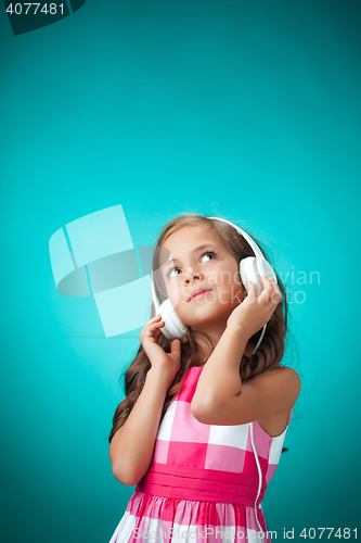 Image of The cute cheerful little girl on orange background