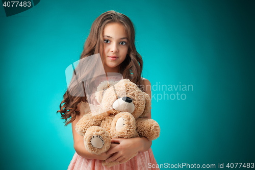 Image of The cute cheerful little girl on blue background