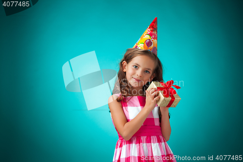 Image of The cute cheerful little girl on blue background