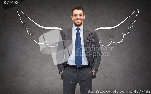 Image of happy businessman with angel wings over gray