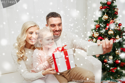 Image of family taking selfie with smartphone at christmas