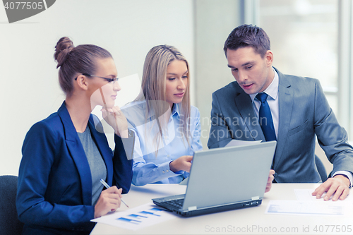 Image of business team with laptop having discussion