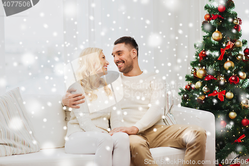 Image of happy couple at home with christmas tree