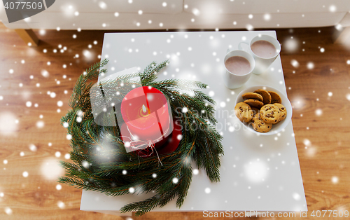 Image of close up of christmas wreath with candle on table