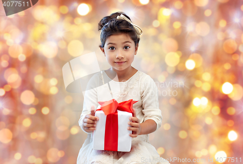 Image of smiling little girl with gift box