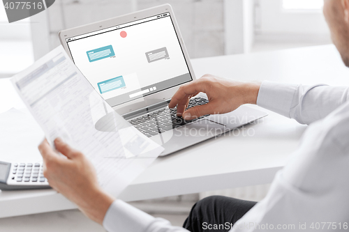 Image of businessman with laptop computer working at office