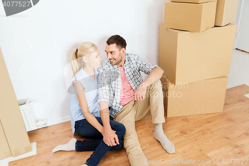 Image of couple with cardboard boxes moving to new home