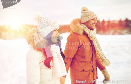 Image of happy couple walking over winter background