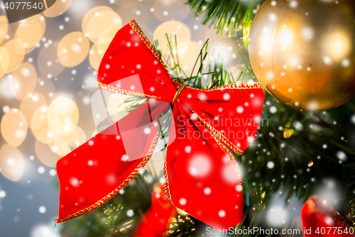 Image of close up of red bow decoration on christmas tree