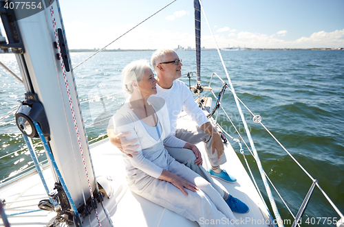 Image of senior couple hugging on sail boat or yacht in sea