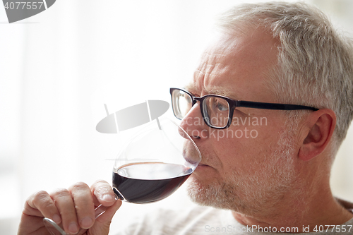 Image of close up of senior man drinking wine from glass