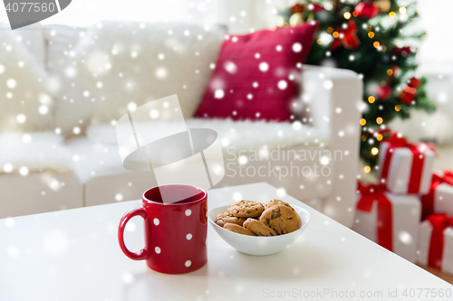 Image of close up of christmas cookies and red cup on table