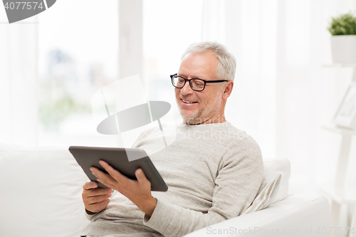 Image of senior man with tablet pc at home