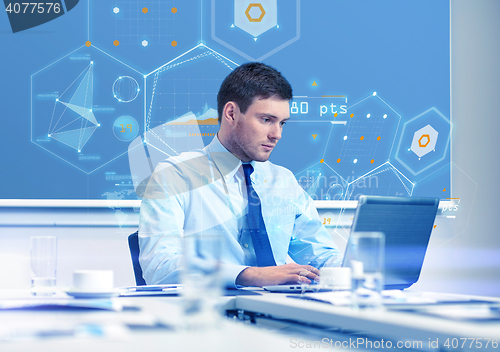 Image of businessman with laptop working in office