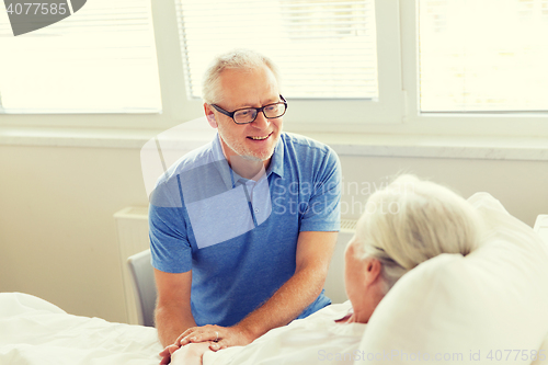 Image of senior couple meeting at hospital ward