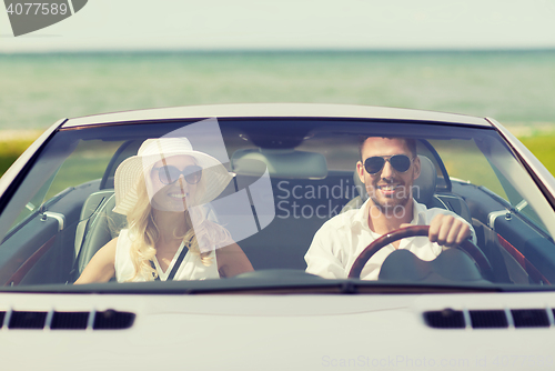 Image of happy man and woman driving in cabriolet car