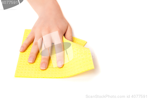 Image of Female hand removes dust from surface.