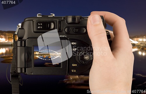 Image of Digital Camera photo in a hand isolated on withe background. lcd screen and background can be easily edited