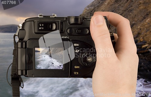 Image of Digital Camera photo in a hand isolated on withe background. lcd screen and background can be easily edited