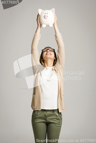 Image of Woman holding piggybank