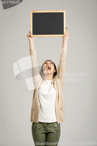 Image of Woman showing something on a chalkboard