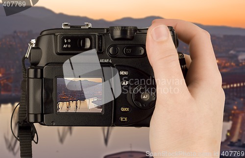Image of Digital Camera photo in a hand isolated on withe background. lcd screen and background can be easily edited