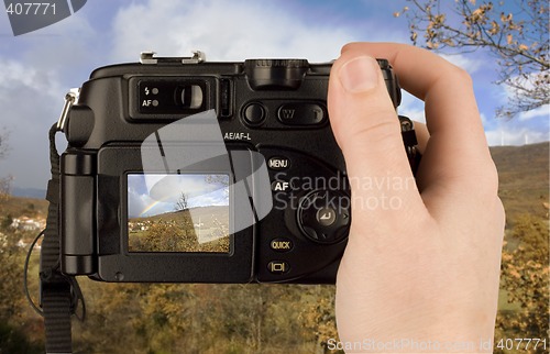 Image of Digital Camera photo in a hand isolated on withe background. lcd screen and background can be easily edited