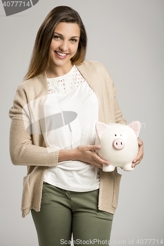 Image of Woman holding piggybank