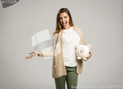 Image of Woman holding piggybank