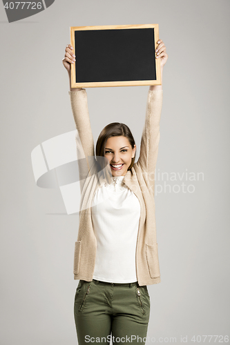 Image of Woman showing something on a chalkboard