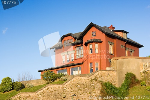 Image of Construction House architecture building with a garden in a residential area.