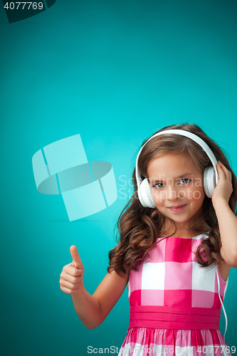 Image of The cute cheerful little girl on orange background