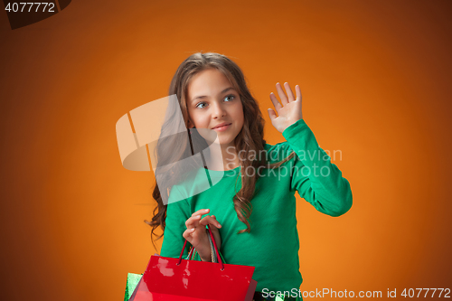 Image of The cute cheerful little girl with shopping bags