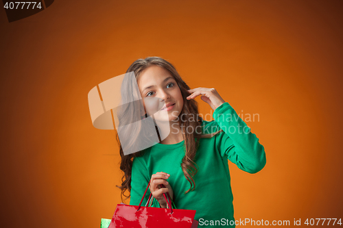 Image of The cute cheerful little girl with shopping bags