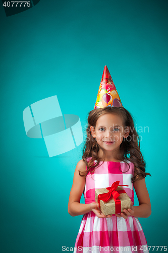Image of The cute cheerful little girl on blue background