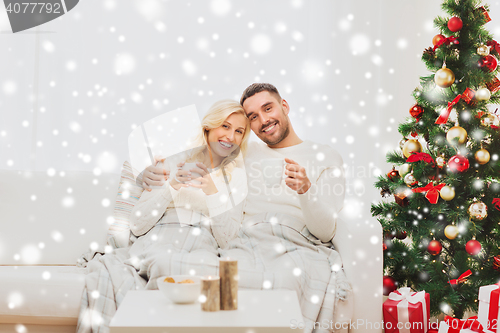 Image of happy couple at home with christmas tree