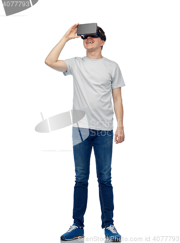 Image of happy man in virtual reality headset or 3d glasses