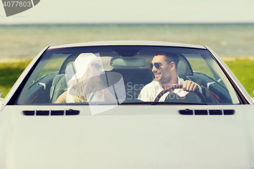 Image of happy man and woman driving in cabriolet car