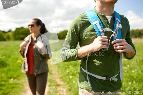 Image of close up of couple with backpacks hiking outdoors