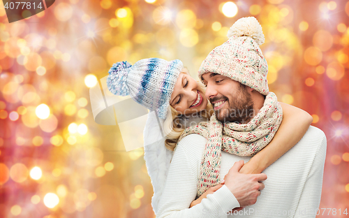 Image of smiling couple in winter clothes hugging