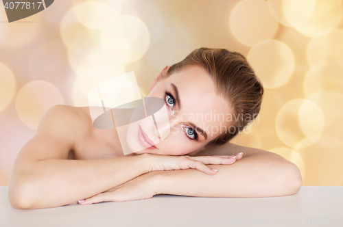 Image of beautiful woman face over holidays lights
