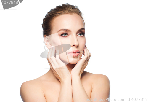 Image of beautiful young woman touching her face