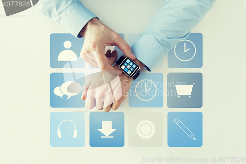 Image of hands with application icons on smart watch