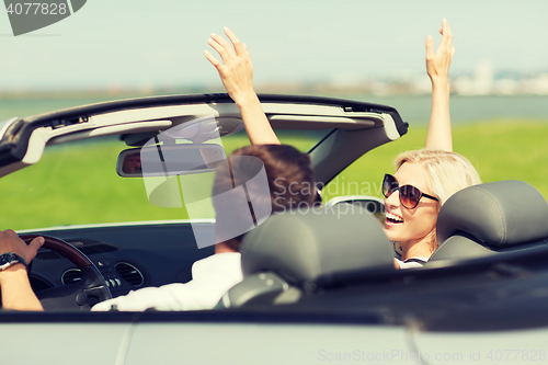 Image of happy man and woman driving in cabriolet car