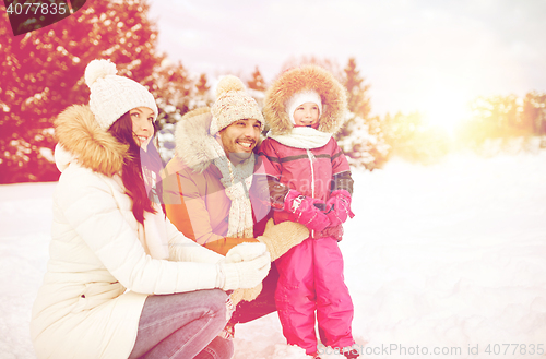 Image of happy family with child in winter clothes outdoors