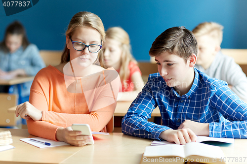 Image of students with smartphone texting at school